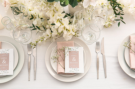 A charming pink and white table setting at a wedding or reception